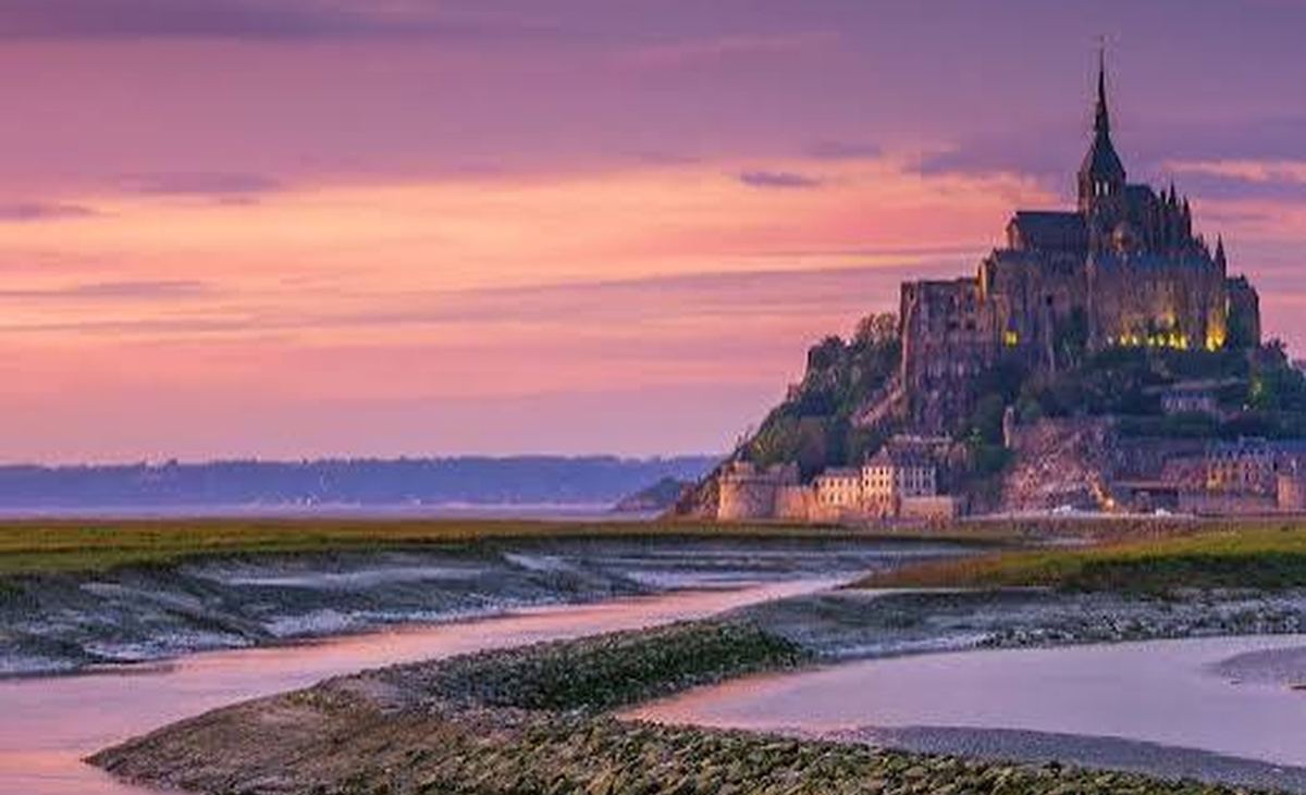 Mont-Saint-Michel abbey at sunset over the bay